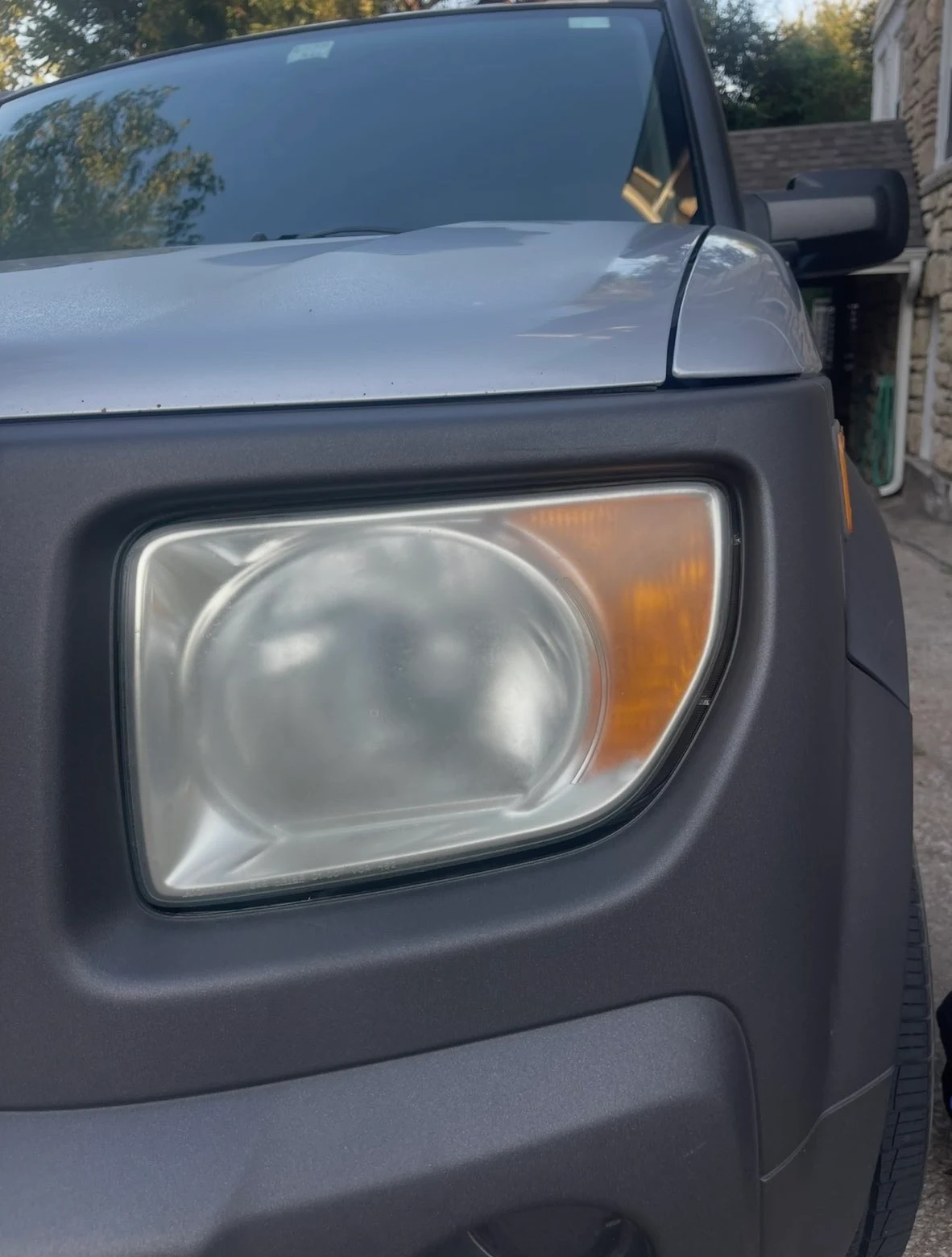 Before: foggy oxidized headlight — mobile headlight restoration Kansas City