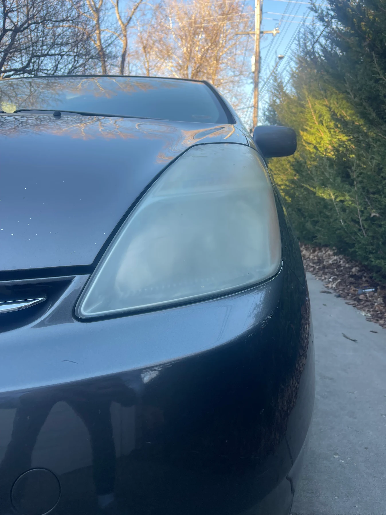 Before: yellowed oxidized headlight — headlight restoration service Kansas City MO